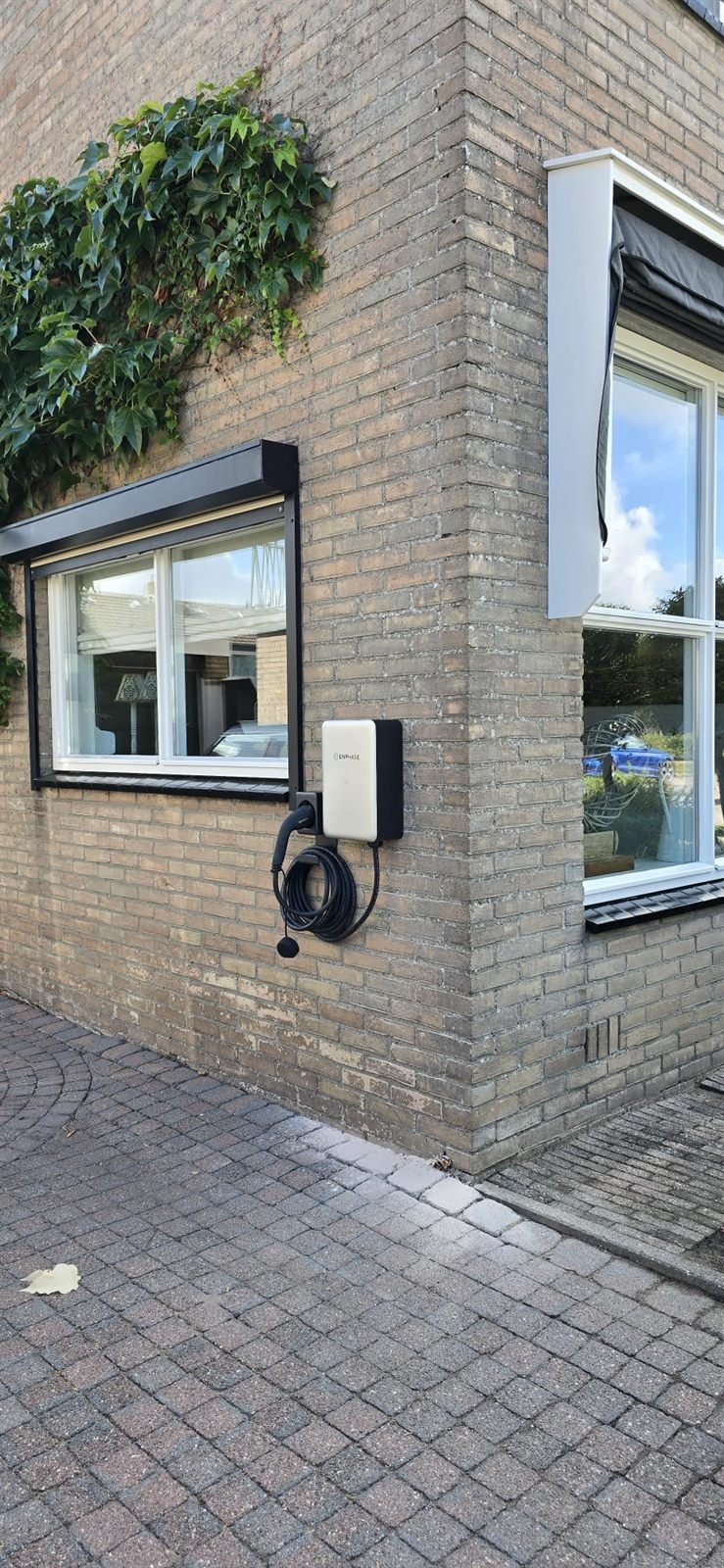 Wand met zes Enphase thuisbatterijen, onderdeel van een samenhangend energiesysteem